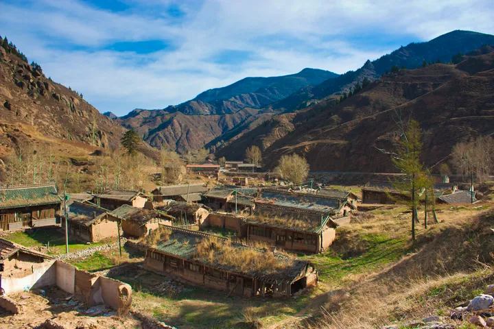 A small rural village with mud-brick courtyard homes in a mountain valley