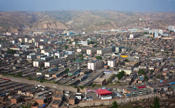 An elevated panorama of Pianguan county town surrounded by loess hills