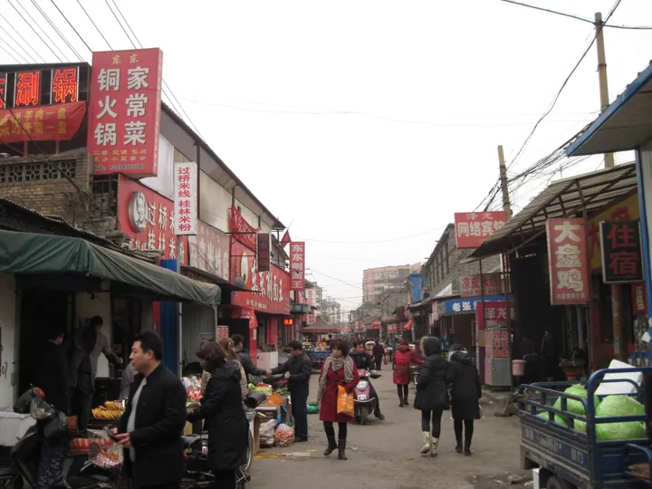 A market street with shops and pedestrians in Yaodu District, Linfen