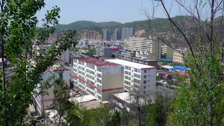 View of a town among hills, seen from a mountainside in Pu County