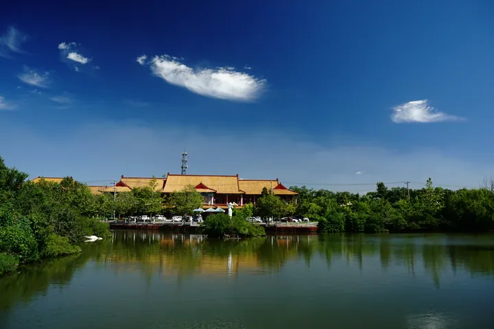 Traditional Chinese temple buildings beside a lake at Qianshan