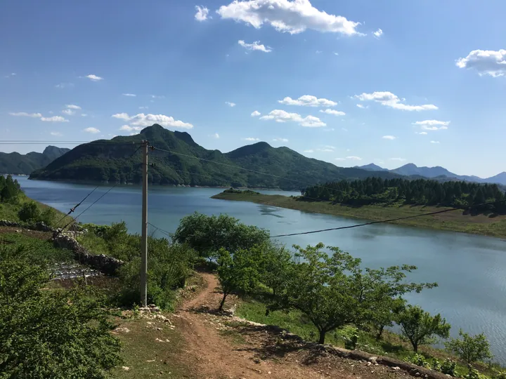 Scenic reservoir surrounded by forested hills in Benxi Manchu Autonomous County