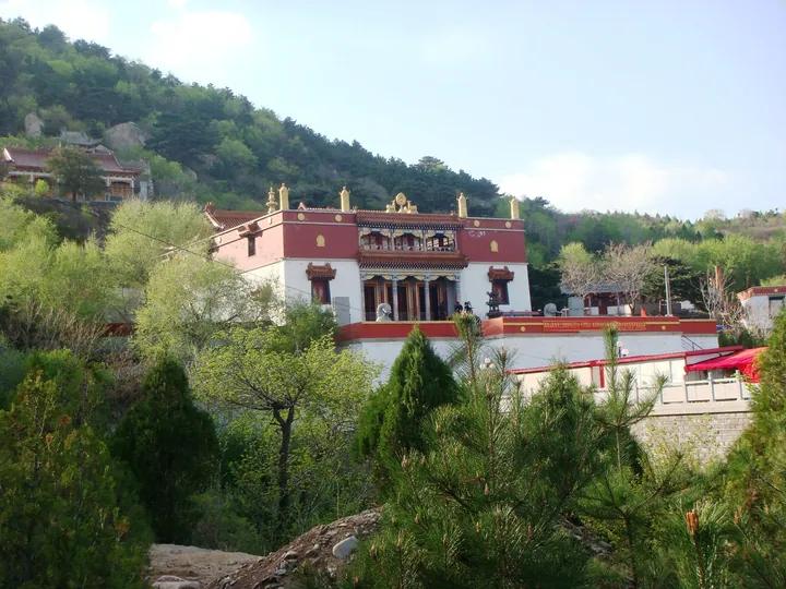 Lama temple building on a forested hillside in Fuxin Mongol Autonomous County