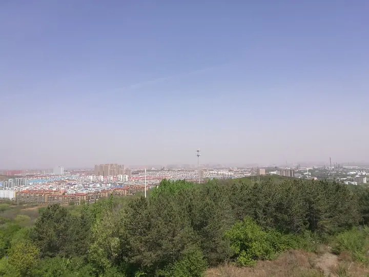 Hazy skyline of Hongwei District seen from a wooded hilltop