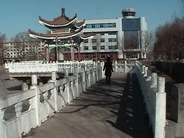 An ornate Chinese-style gate bridge over the Lotus Lake