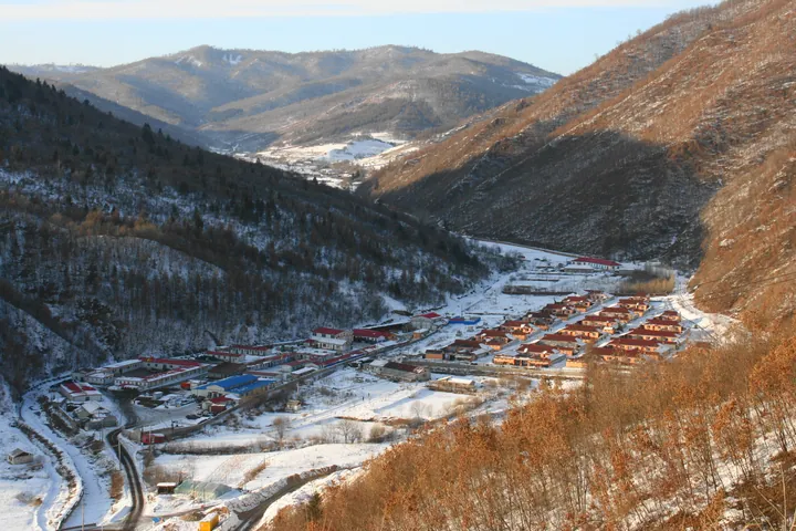 Snowy mountain valley settlement in Hunjiang District