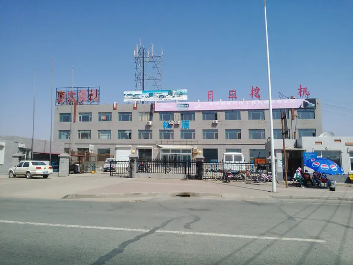 Street-level view of a multi-storey building with rooftop signage in downtown Qian Gorlos