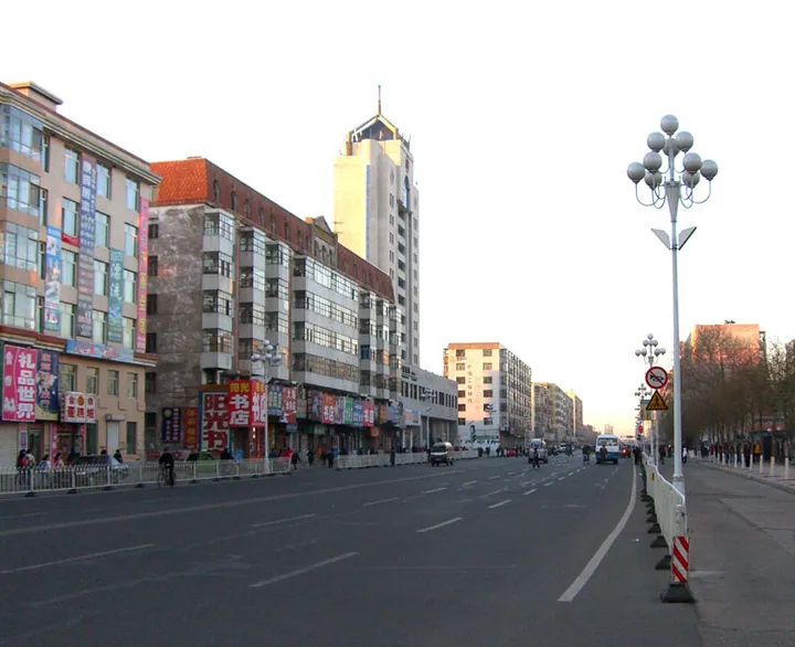 City street with a clock-tower building on Zhengyang Street in Zhaodong