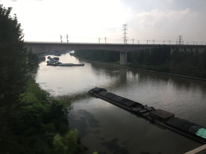 River barges beneath a railway bridge in Gulou District, Xuzhou