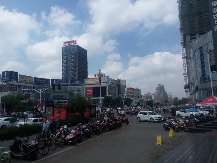 Busy city-centre intersection with high-rise buildings in Huashan District