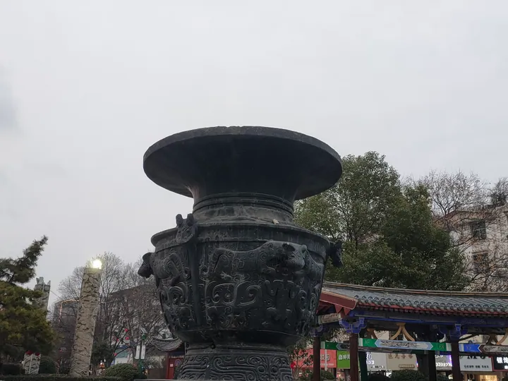 Large bronze vessel sculpture in a park in Funan County