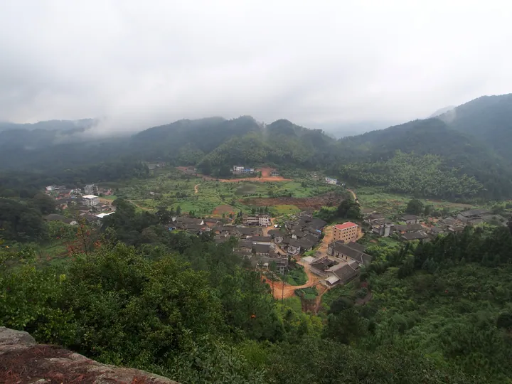 Misty mountain valley with a village in Yongtai County