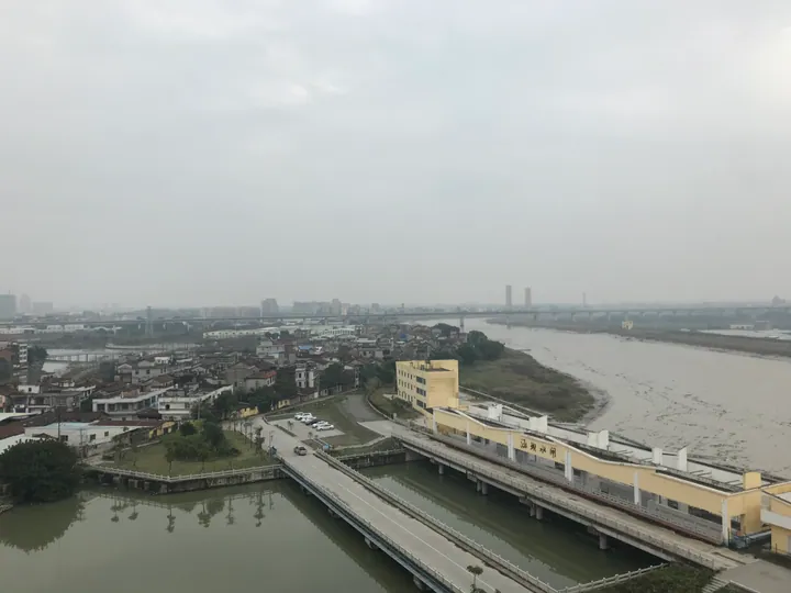 Riverside townscape with a floodgate building in Hanjiang District, Putian