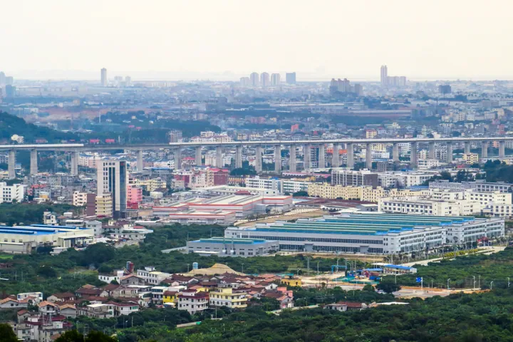Cityscape of Licheng District, Putian, seen from a hillside with a railway viaduct