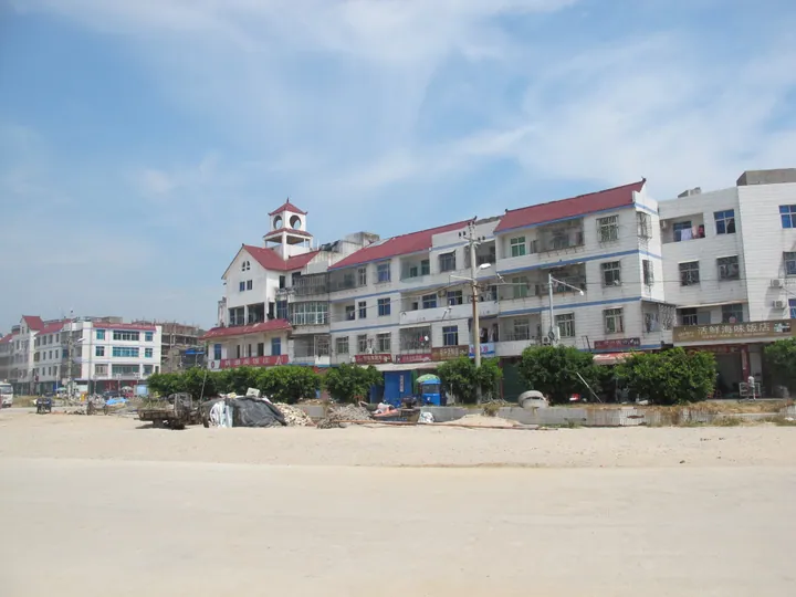 Coastal street with a clock-tower building in Xiuyu District