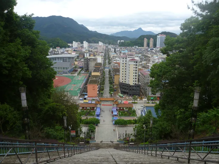 Elevated view of Datian County town centre with surrounding mountains