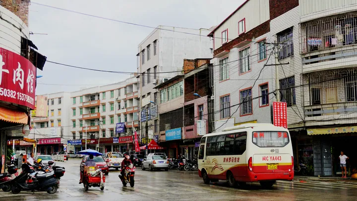 Street scene with shops and traffic in Luoxi town, Luojiang District