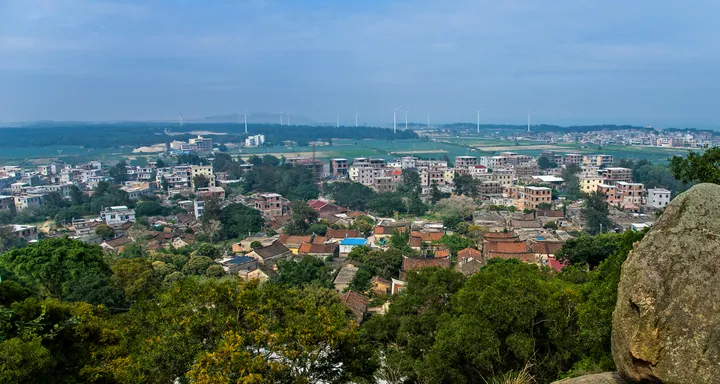 Elevated view of a coastal village with wind turbines near Liu'ao, Zhangpu County