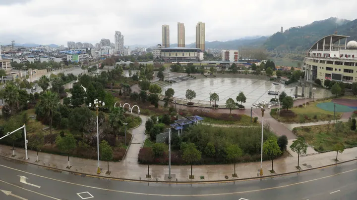 Public square with a pagoda and city skyline in the background, Jian'ou