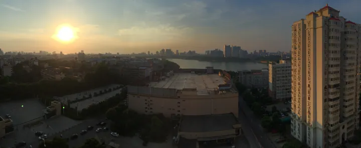 City skyline and a lake at sunset in Xunyang District, Jiujiang