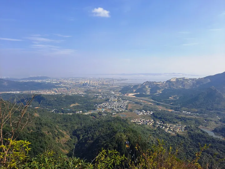 Panoramic view of Lushan City and the lake from Mount Xiufeng, with wind turbines on the ridge