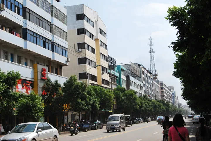 Town street with shops, pedestrians and traffic in Ganxian District