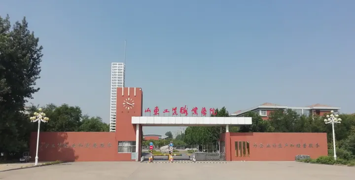 A red brick campus gate with a clock tower in Huantai County, China