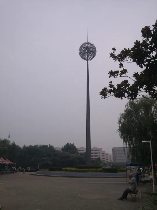 Plaza with a tall dandelion-shaped light sculpture in Xinhua District, Pingdingshan