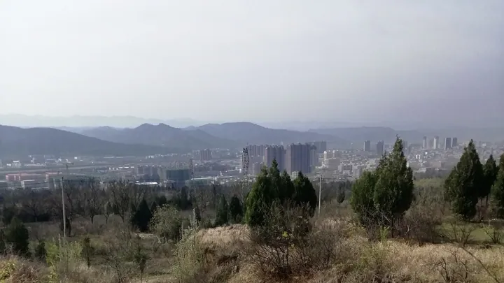 A distant view of a county town in a valley surrounded by hills