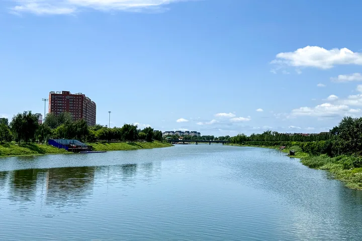 A calm river flowing past riverside buildings in Taikang County