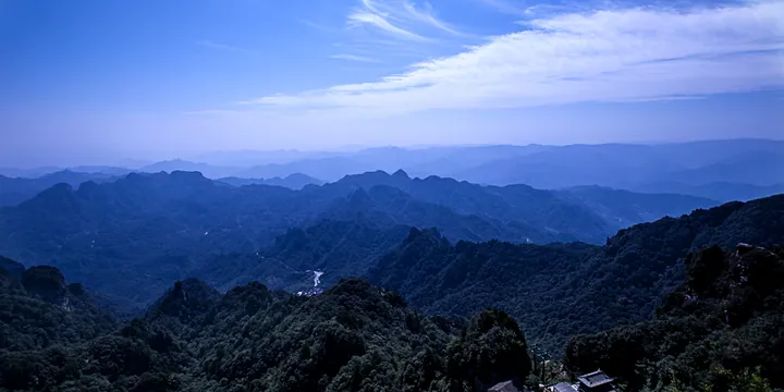 Layered blue mountain ridges under a hazy sky near Danjiangkou