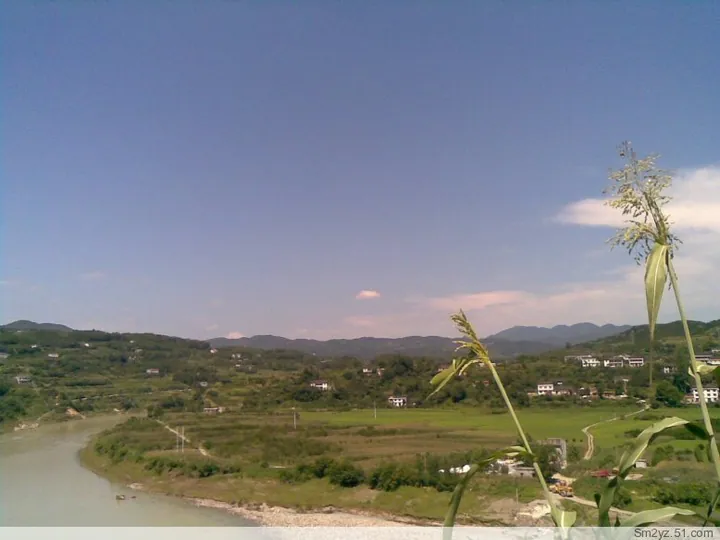 A river bend with green hills and a small village in Shimen County