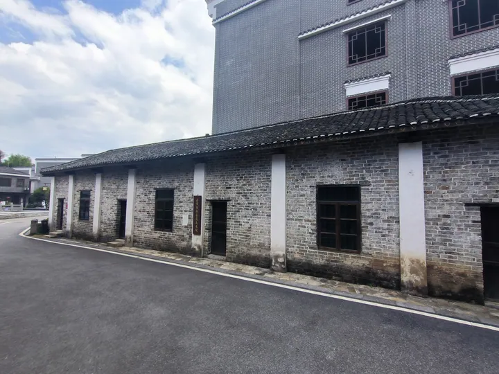 Old grey brick building with traditional tiled roof, part of a protected historical site in Jiahe County