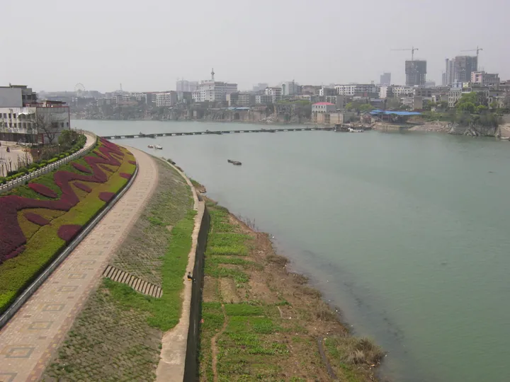River, embankment path and city skyline with construction cranes in Lengshuitan District