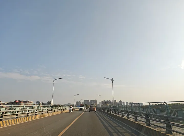 A road bridge over the Xiang River with the Qiyang skyline in the distance