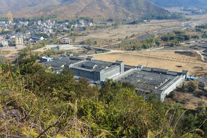 An aerial view of the large rectangular Mantang Wei walled compound and surrounding valley in Shixing County