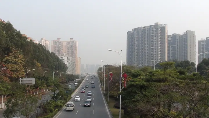 A multi-lane boulevard with high-rise buildings on both sides in Bao'an District, Shenzhen