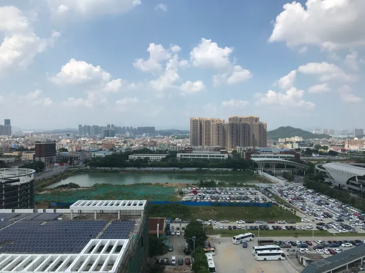 Skyline view of Pingshan District, Shenzhen, under a partly cloudy sky