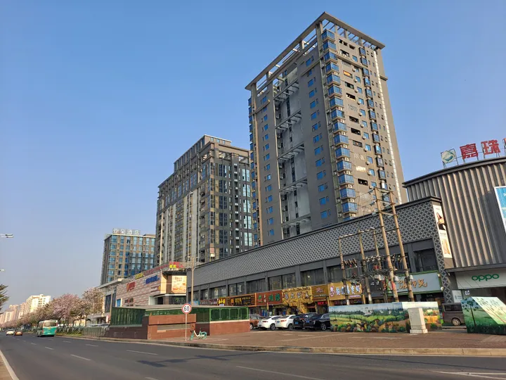 Tall modern residential and commercial towers along a street in Sanzao, Zhuhai