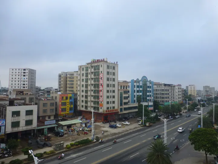 Elevated view of a city street with shops and traffic in downtown Leizhou