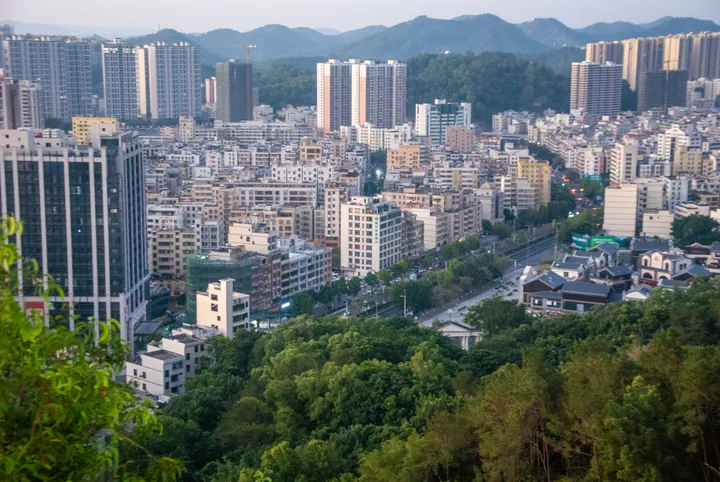 Elevated view of the city of Xinyi with hills in the background, seen from a park