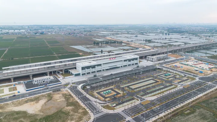 An aerial view of Huilai Railway Station's building, forecourt and surrounding farmland
