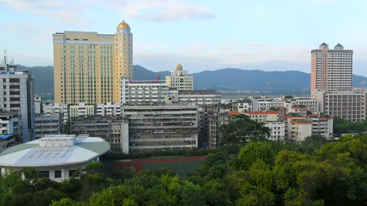 Wuzhou city skyline with highrises and hills, Wanxiu District