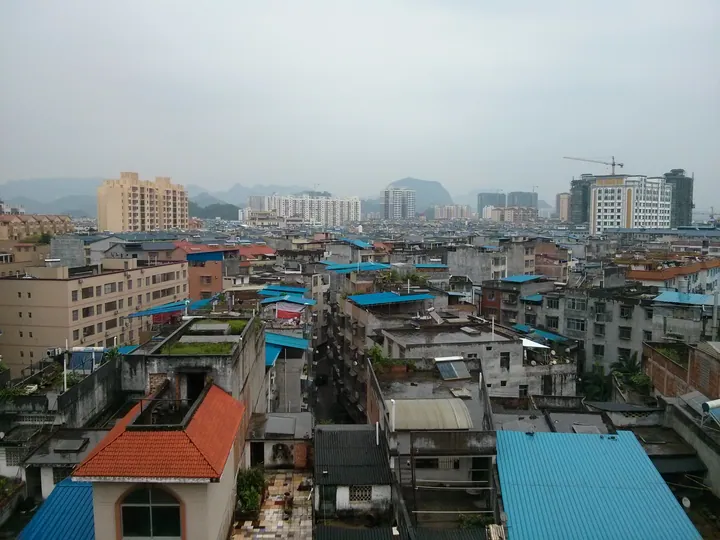 Elevated view of rooftops and hills in Pingguo