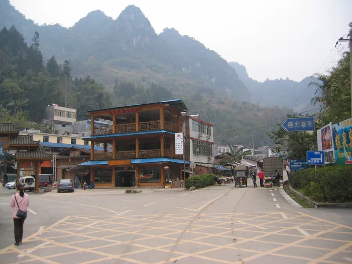 Traditional buildings and a market street with karst hills in Suolong Town, Daxin County