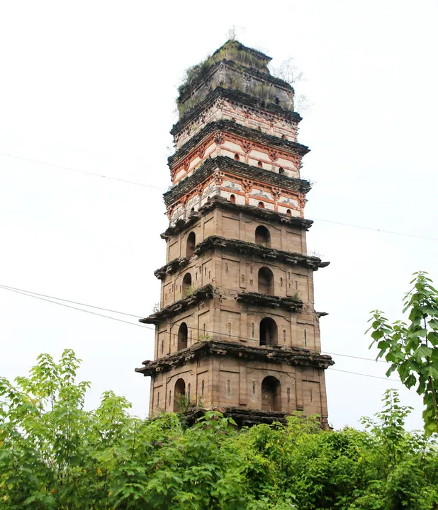 Tall historic pagoda rising above trees in Guang'an District