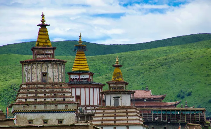 Three ornate Tibetan Buddhist stupa towers at Dzamthang Tsangwa Monastery