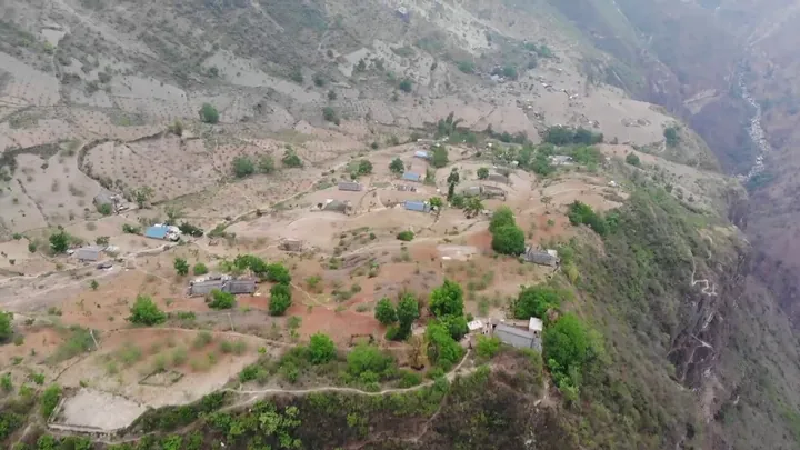 Village clinging to a steep mountainside in Zhaojue County