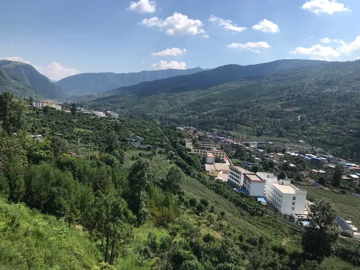 Hillside view of a valley town in Xide County