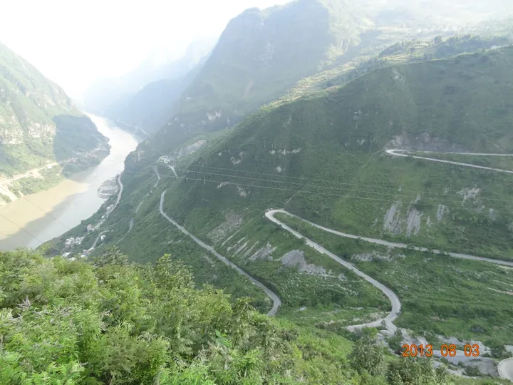 Winding mountain road above the river en route to Ma Lake in Leibo County
